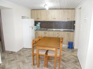 a kitchen with a table and chairs and a refrigerator at Dream House in Theológos