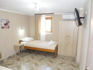 a small bedroom with a bed and a tv in it at Dream House in Theológos