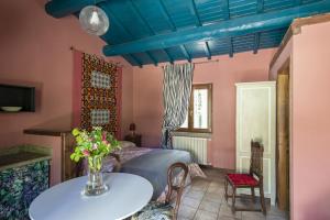 a bedroom with a table and a blue ceiling at parco dei cimini in Soriano nel Cimino