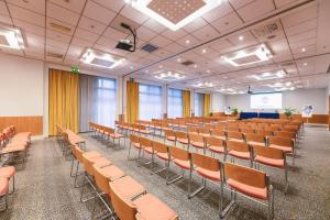 an empty lecture hall with chairs and a podium at Novotel Venezia Mestre Castellana in Mestre +59 photos