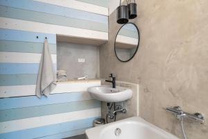 a bathroom with a sink and a mirror and a tub at pestahome in Hannover +63 photos