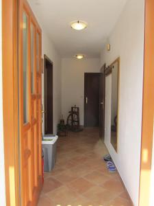 a hallway of a bathroom with a toilet and a door at Apartment Rakušček in Kobarid