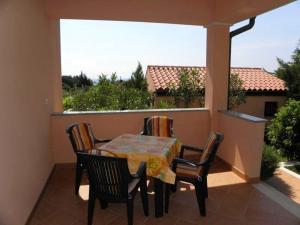 a table and chairs on a balcony with a view at Apartment in Premantura with terrace, air conditioning, WiFi, washing machine 3352-27 in Premantura