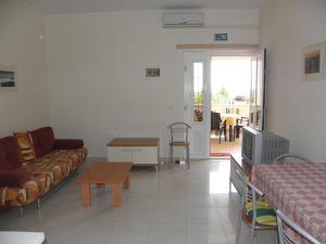 a living room with a couch and a tv in it at Apartment in Premantura with terrace, air conditioning, WiFi, washing machine 3352-27 in Premantura