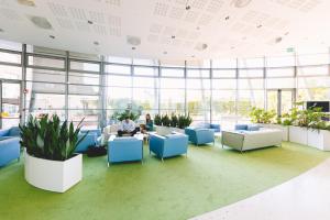 a large office with people sitting at tables and chairs at Novotel Venezia Mestre Castellana in Mestre