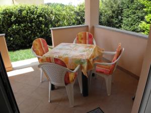 a table and chairs sitting on a porch with a window at Apartment in Premantura with terrace, air conditioning, WiFi, washing machine 3352-28 in Premantura