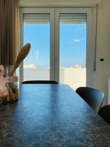 a dining room table with a view of the ocean at Rimini Bay Suites&Residence in Rimini +98 photos