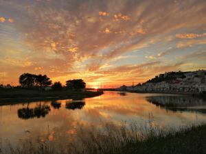 a view of a river at sunset at Largo A2 in Alcácer do Sal