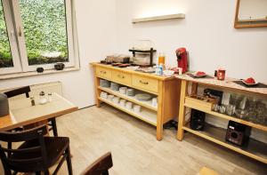 a room with a counter and a table and chairs at Hotel am Schlosspark Essen in Essen