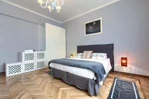 a bedroom with a large bed and a chandelier at Dimora Mantelli in Mestre