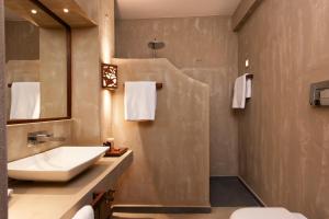 a bathroom with a sink and a mirror at Katogi Averoff Hotel & Winery in Metsovo