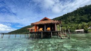 a house on a pier in the water at Nyande Raja Ampat in Pulau Mansuar