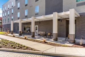 a patio outside of a building with a table and chairs at MainStay Suites Murfreesboro in Murfreesboro