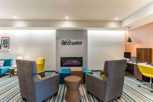 a lobby with chairs and a welcome sign on a wall at MainStay Suites Murfreesboro in Murfreesboro