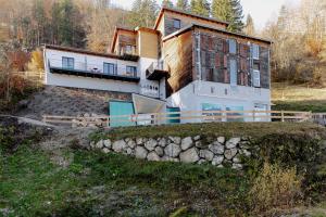 a house on a hill with a stone wall at Bett & Berg Bad Ischl, Self Check-In in Bad Ischl