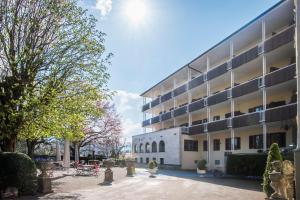 a building with a courtyard in front of it at Hotel Rex in Bad Wiessee