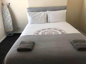 een slaapkamer met een bed met twee handdoeken erop bij Hinton House in Liverpool