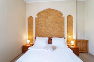 Ένα ή περισσότερα κρεβάτια σε δωμάτιο στο Dakkar Hotel