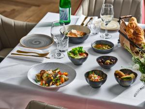 a table with plates of food and glasses of wine at David InterContinental Tel Aviv  in Tel Aviv