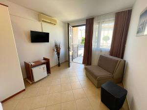 a living room with a couch and a television at Apartmani Selina in Jadranovo