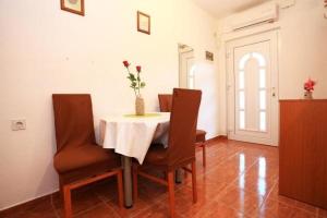 jadalnia ze stołem z krzesłami i wazonem z kwiatami w obiekcie Apartment in Kali with sea view, balcony, air conditioning WiFi 4675-1 w mieście Kali