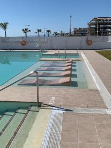 a large swimming pool with several lanes of water at Appartement Duna beach 2 in Torrox Costa