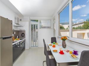 a kitchen and dining room with a table and chairs at Apartments St Thomas in Dubrovnik