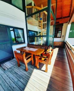 a wooden table and two benches on a deck at Lamplhof in Wiesing