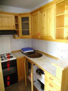 a kitchen with wooden cabinets and a sink at Holiday Home Pri Srni in Bohinj