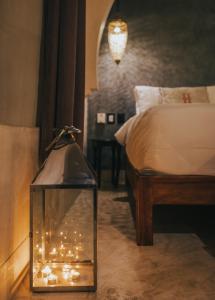 a bedroom with a bed and a lantern with lights at Ambre & Epices Jungle Hotel & Spa in Tulum