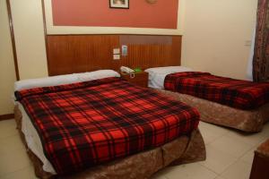 Postel nebo postele na pokoji v ubytování New Saint Catherine Hotel