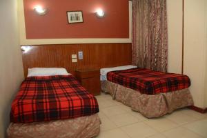Postel nebo postele na pokoji v ubytování New Saint Catherine Hotel
