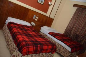 Postel nebo postele na pokoji v ubytování New Saint Catherine Hotel