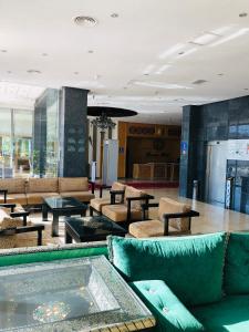 a lobby with couches and tables in a building at Dream's Hotel in Tétouan