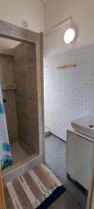 a bathroom with a shower and a toilet and a sink at Villa Camélias in La Plaine des Palmistes