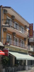 a large building with tables and chairs in front of it at Hostal Milenium in Els Monjos