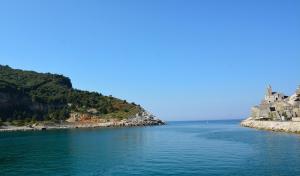 an island with a castle in the middle of the water at Grand Hotel Portovenere in Portovenere