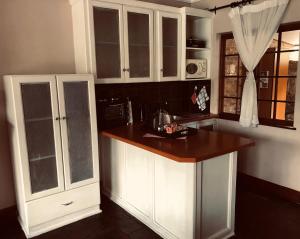 a kitchen with white cabinets and a counter top at Trout River Falls in Lydenburg