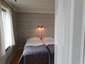 A bed or beds in a room at Lövånger Kyrkstad