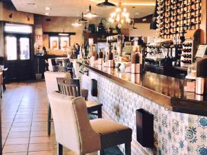 a bar in a restaurant with chairs and a counter at Casa Lola in Rueda