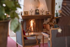a fireplace in a living room with a fire place at Waldhotel Doldenhorn in Kandersteg