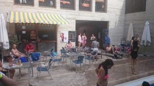 a group of people sitting at tables and chairs at Hostal Rural San Andrés in Torres del Río