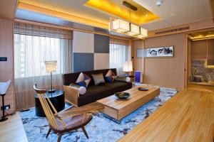 a living room with a couch and a table at Hotel New Otani Chang Fu Gong in Beijing