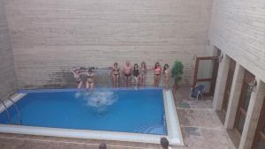 a group of women in bathing suits standing next to a swimming pool at Hostal Rural San Andrés in Torres del Río