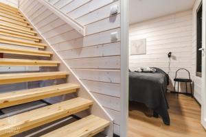 a staircase leading up to a bedroom in a tiny house at Holiday In Lapland - SointuiLevi A69 in Levi