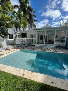 a swimming pool in front of a house at The Conch House Heritage Inn in Key West