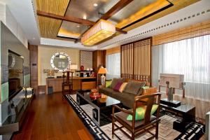 a living room with a couch and a table at Hotel New Otani Chang Fu Gong in Beijing