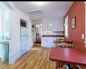 a kitchen and dining room with a table in a room at Sunny Home B&B in Charlottetown
