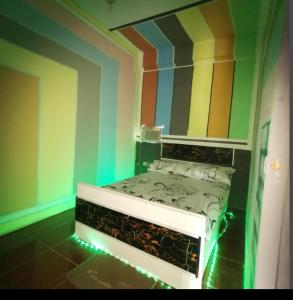 a room with a bed with a colorful wall at Cabanatuan City PNY TRANSIENT INN 3 in Cabanatuan