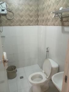 a bathroom with a toilet and a sink at DJCI Apartelle with own bath & kitchen 101-211 in Cabanatuan
